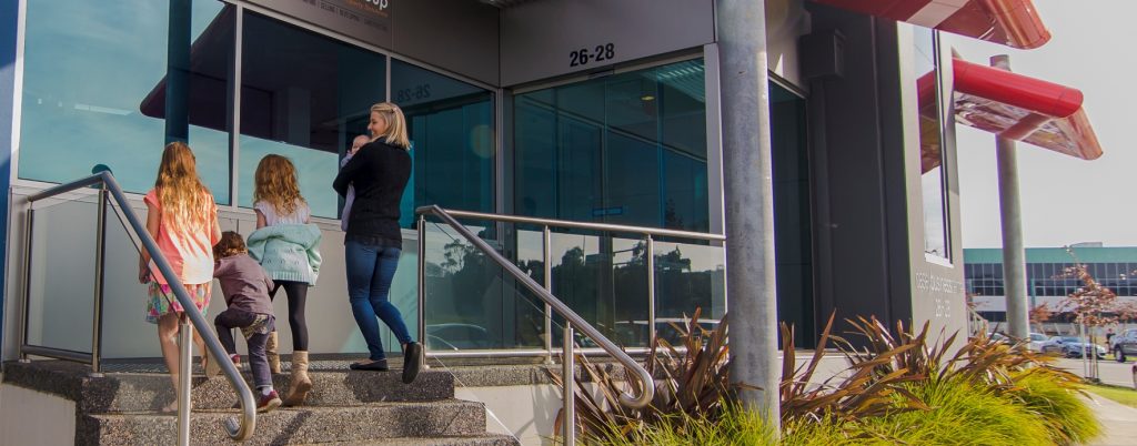Family walking into clinic